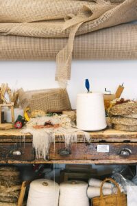 Neutral cotton yarn skeins arranged on a warm wooden craft table