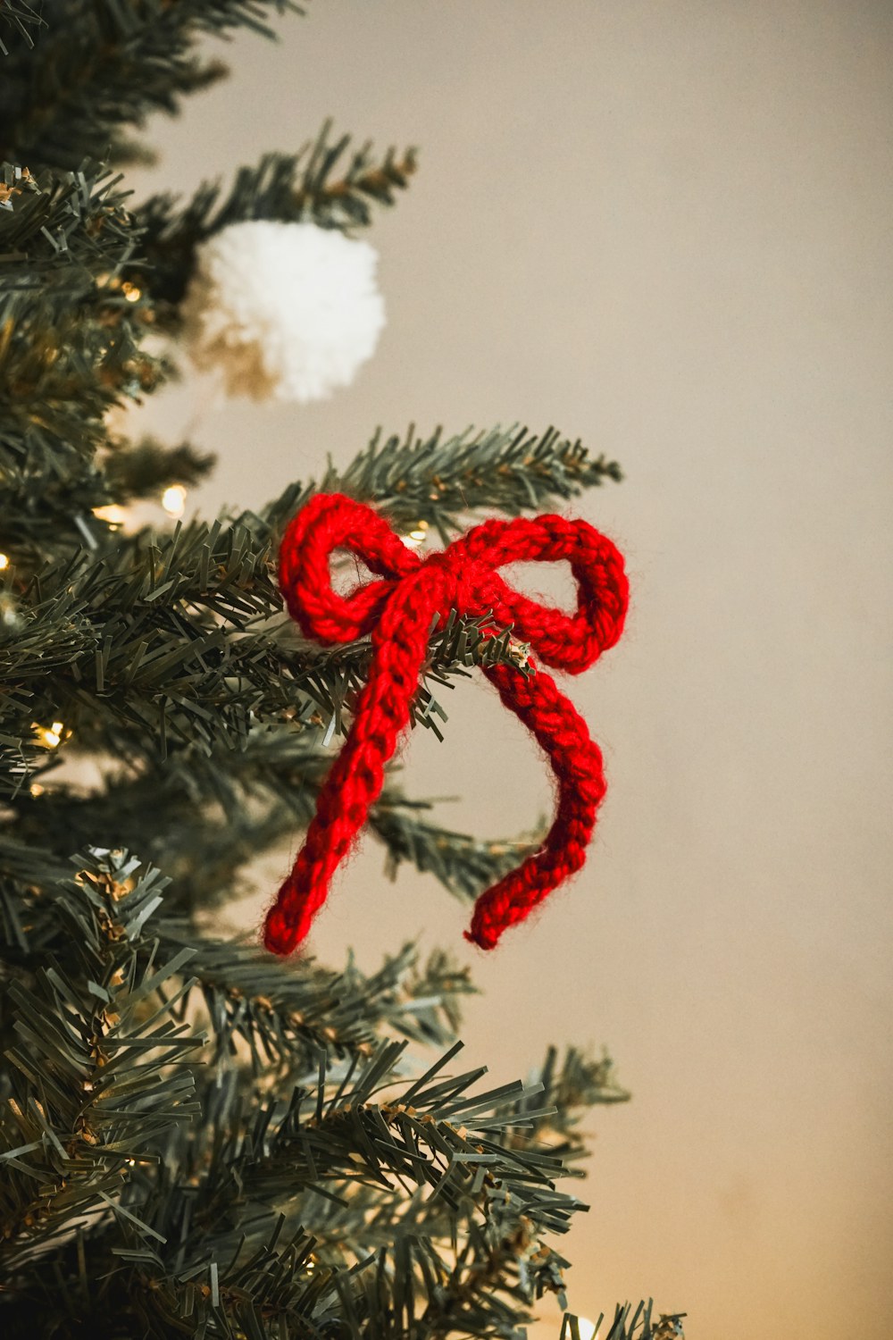 Handmade crochet ornament styled on a warm festive tree in natural light
