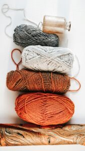 Different yarn skeins showing a range of crochet yarn weights and textures