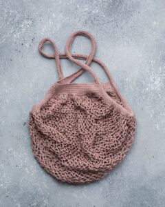 Crochet mesh market bag flat lay for a summer double crochet mesh project