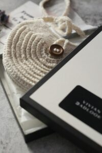 Handmade textured yarn pouch photographed upright in a clean neutral studio