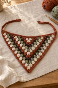 Handmade granny stitch triangle crochet bandana styled in warm autumn colors