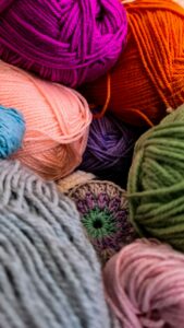 Soft wool yarn skeins stacked in a cozy craft room
